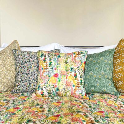 Liberty fabric cushions on bed